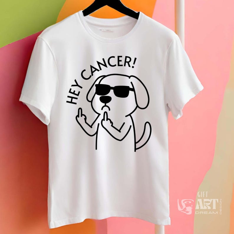 May include: White t-shirt with a black and white illustration of a dog wearing sunglasses and giving the middle finger. The text "HEY CANCER!" is written above the dog.