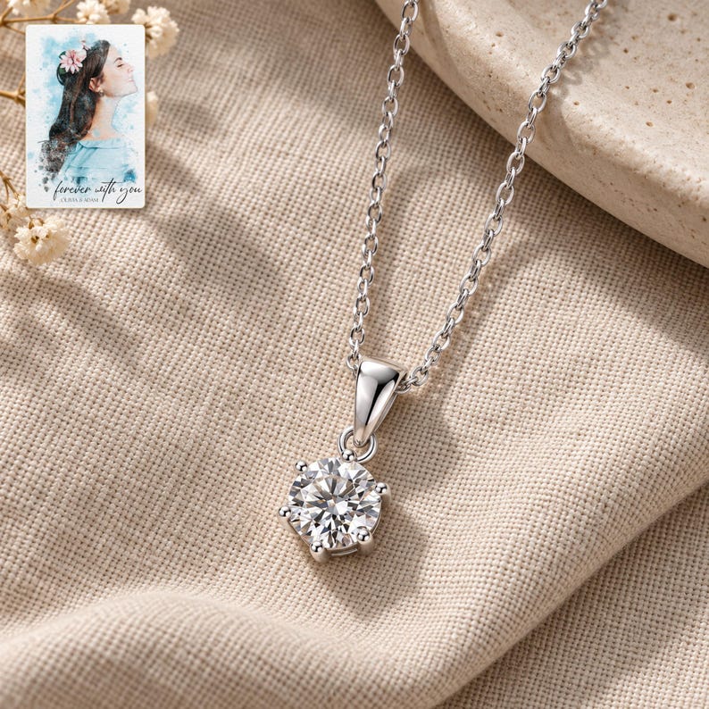 Moissanite Pendant Necklace, laid on fabric. A sample personalized digital greeting card is shown alongside.