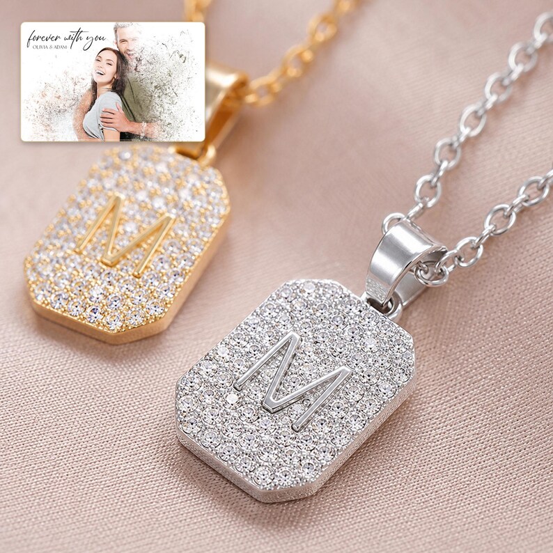 Mosaic Initial M Necklace Duo shown during a warm gift-receiving moment between adults with the exact jewelry visible.