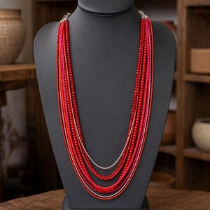 Gift ready presentation of Long multistrand scarlet red pink and silver necklace in an open jewelry box lined with natural ivory linen