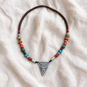 Multicolor Triangle Pendant Necklace presented in an open jewelry gift box on natural linen