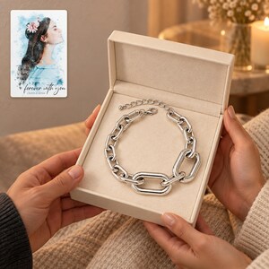 silver tone Arc Statement Choker shown during a warm gift-receiving moment between adults with the jewelry visible. A personalized digital greeting card is shown alongside.