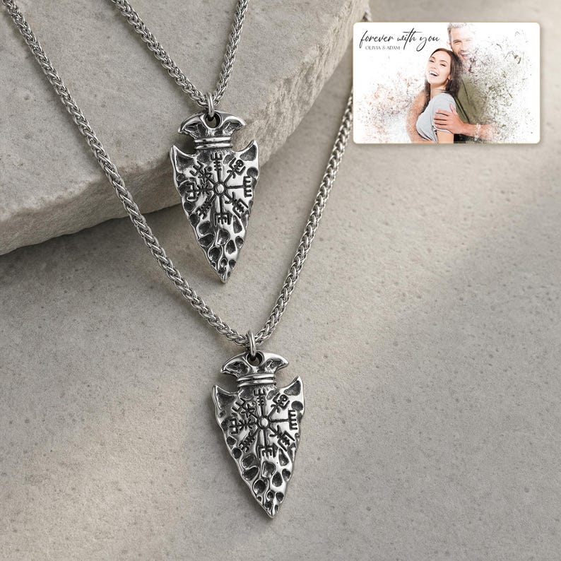 Aegis North Nordic Arrowhead Necklace photographed in warm natural window light in an elegant home setting.
