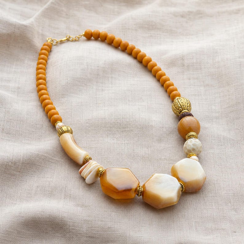 Silver and Brown Statement Beaded Necklace presented in an open jewelry gift box on natural linen