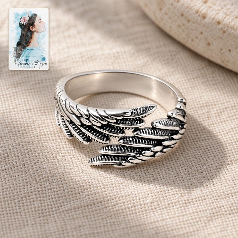 Angel Wings Wrap Ring, laid on fabric. A sample personalized digital greeting card is shown alongside.