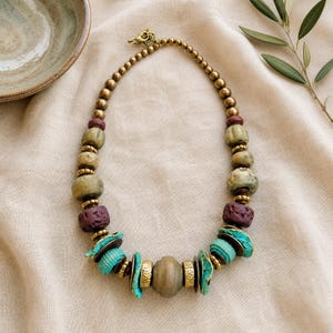 Rose Gold and Gray Statement Beaded Necklace presented in an open jewelry gift box on natural linen