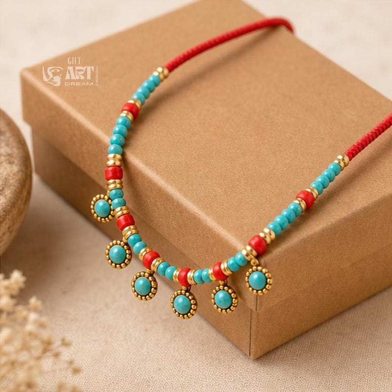 Gift box and close-up detail photo of turquoise and red beaded gold tone charm necklace for handmade jewelry gifting
