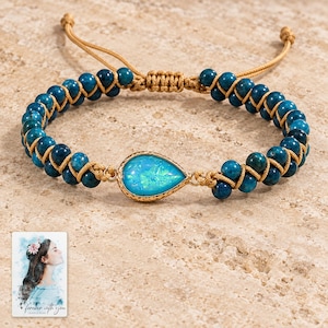 Blue Teardrop Cord Bracelet, shown on a display surface. A sample personalized digital greeting card is shown alongside.