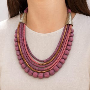 Rose Gold and Brown Statement Beaded Necklace presented in an open jewelry gift box on natural linen