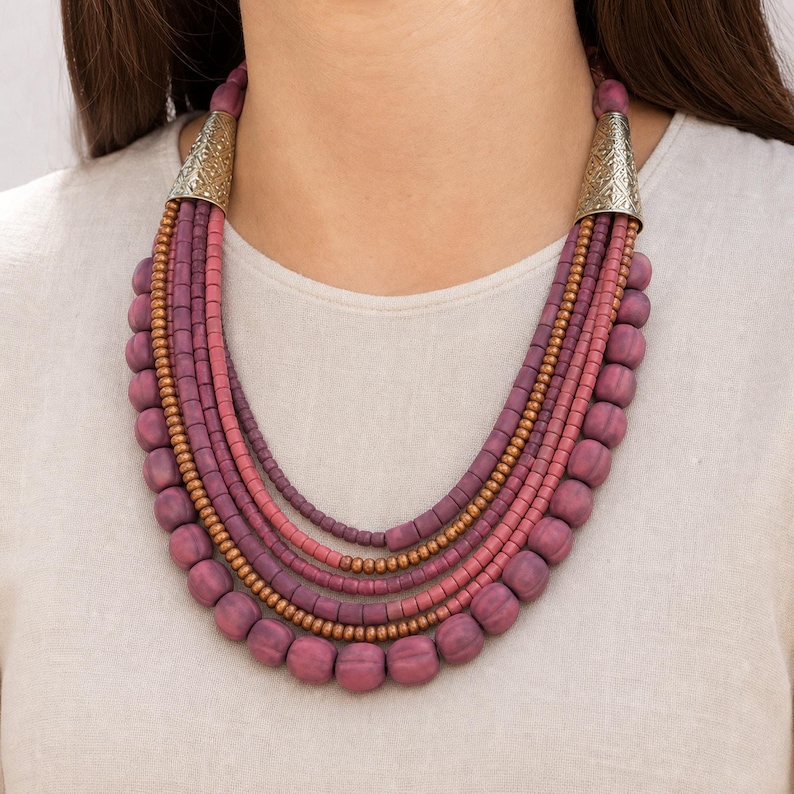 Rose Gold and Brown Statement Beaded Necklace presented in an open jewelry gift box on natural linen