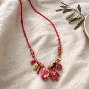 Gray and Red Statement Beaded Necklace presented in an open jewelry gift box on natural linen