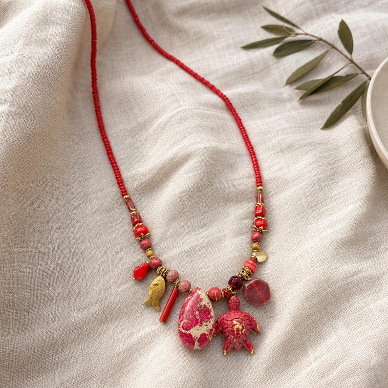 Gray and Red Statement Beaded Necklace presented in an open jewelry gift box on natural linen