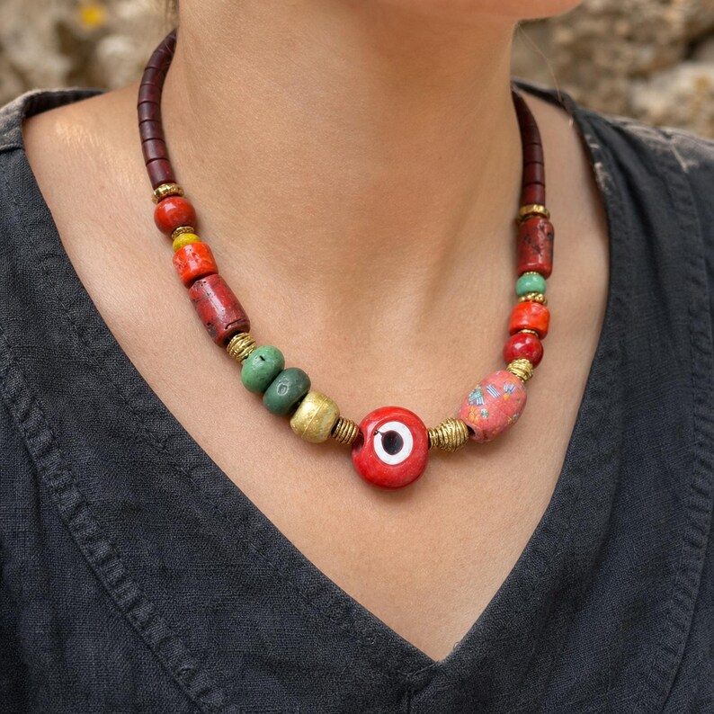 Three-piece handmade necklace set featuring red evil eye beaded necklace, turquoise beaded fish evil eye beaded necklace and red evil eye beaded necklace, displayed together to show the coordinated colors and beadwork