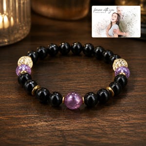 Violet Dusk Bead Bracelet arranged on soft ivory linen in a refined neutral flat lay.