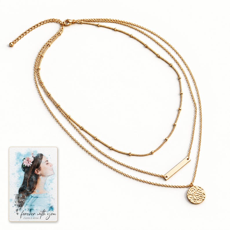 Full gold-tone necklace arranged on a warm-white surface, with all three chains, shared clasp and extension visible. A personalized digital greeting card is shown alongside.