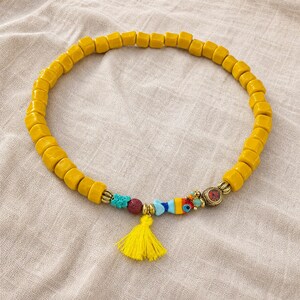 Gift ready presentation of Yellow and Gold Statement Beaded Necklace in an open jewelry box lined with natural ivory linen