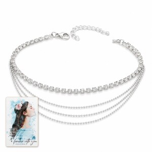 Silver Starlight Layered Anklet shown during a believable gift-giving moment between adults with the exact jewelry visible.