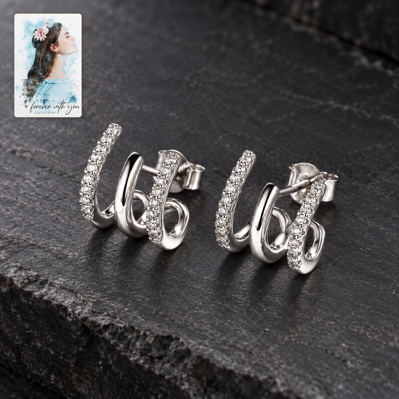 Triple Arc Stud Earrings, shown against a dark background. A sample personalized digital greeting card is shown alongside.