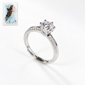 Moissanite Solitaire Ring, shown against a light background. A sample personalized digital greeting card is shown alongside.