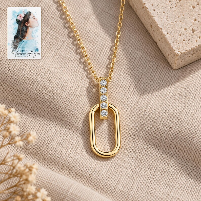 Oval Link Moissanite Necklace, laid on fabric. A sample personalized digital greeting card is shown alongside.