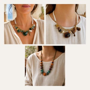 May include: Three necklaces are displayed. The first features white pearls, a gold chain, and green and teal charms. The second has white pearls, a gold chain, and brown shell-like charms. The third is a beaded necklace with orange, brown, and teal beads.