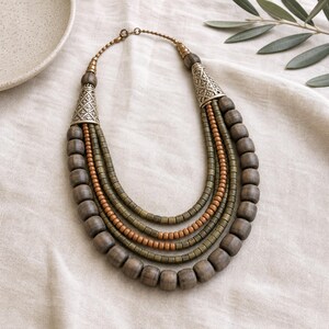 Rose Gold and Beige Statement Beaded Necklace presented in an open jewelry gift box on natural linen