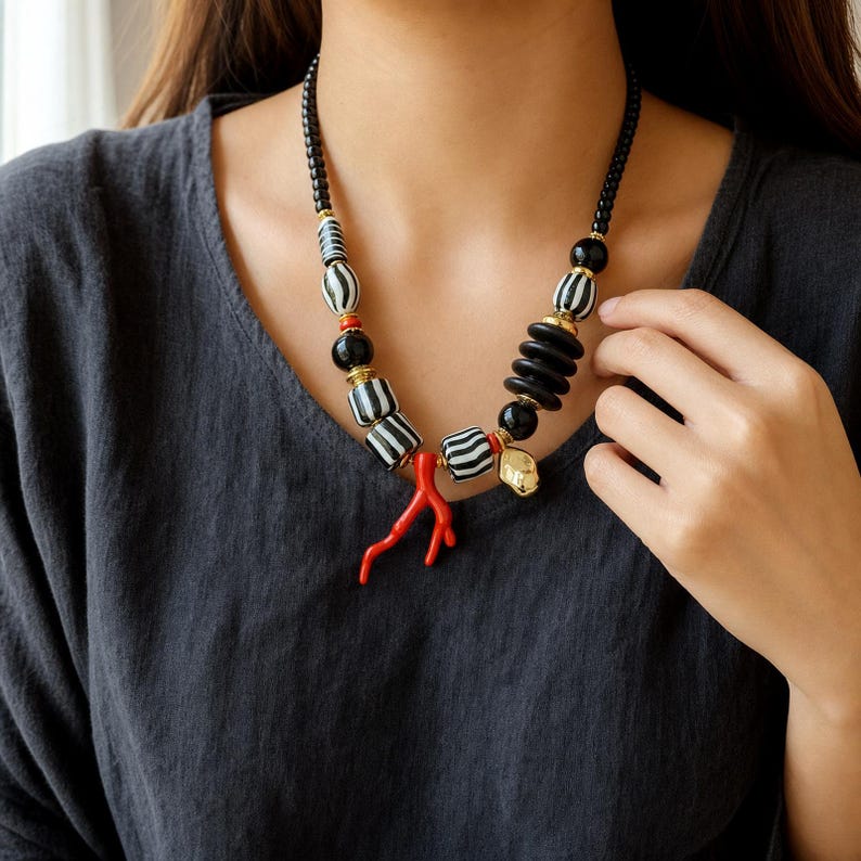 Three-piece handmade necklace set featuring red and silver beaded necklace, silver and beige beaded necklace and beige and silver beaded necklace, displayed together to show the coordinated colors and beadwork