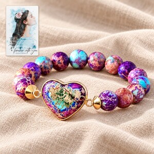 Imperial Mosaic Heart Bracelet arranged on soft ivory linen in a refined neutral flat lay. A personalized digital greeting card is shown alongside.