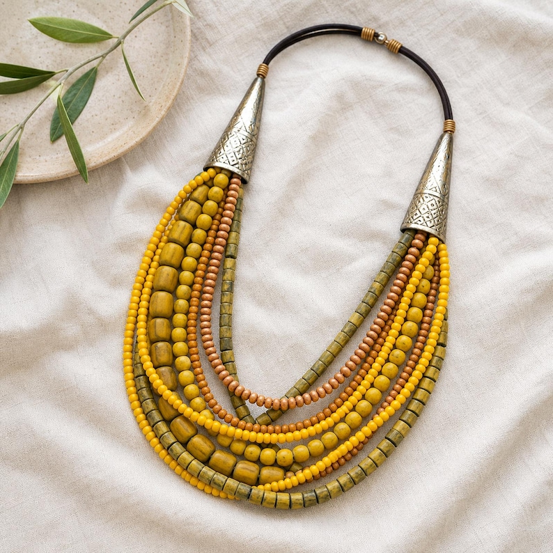 Rose Gold and Gold Statement Beaded Necklace presented in an open jewelry gift box on natural linen
