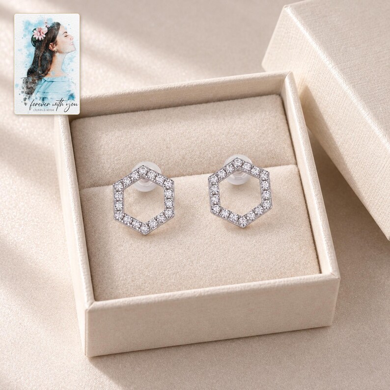 Hexagon Moissanite Stud Earrings, displayed in a presentation box. A sample personalized digital greeting card is shown alongside.