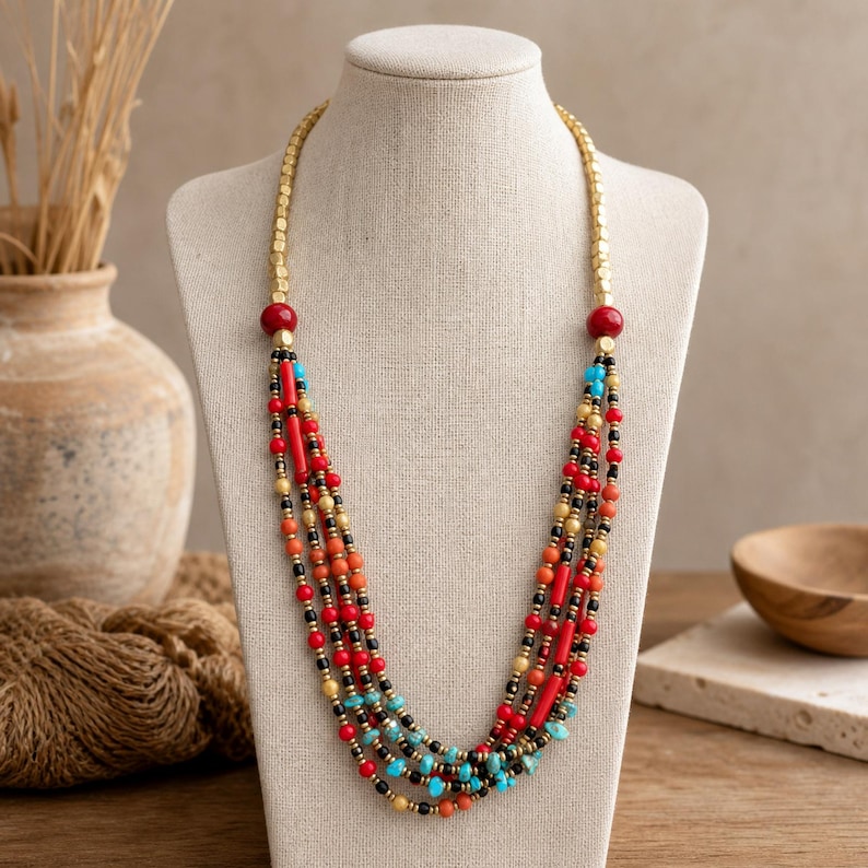 Red and Brown Statement Beaded Necklace, Boho Handmade Jewelry, Artisan Gift for Her displayed on a jewelry bust with the layered beadwork and pendants visible