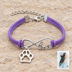 Infinity Love Paw Bracelet, shown on a display surface. A sample personalized digital greeting card is shown alongside.