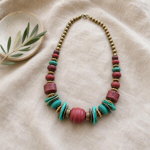 Rose Gold and Gray Statement Beaded Necklace presented in an open jewelry gift box on natural linen