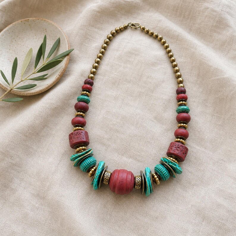 Rose Gold and Gray Statement Beaded Necklace presented in an open jewelry gift box on natural linen