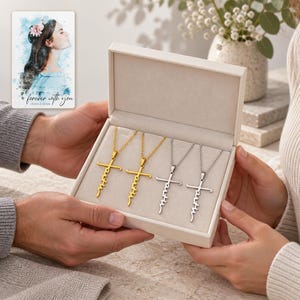 Faith Together Cross Necklace Set shown during a believable gift-giving moment between adults with the jewelry visible. A personalized digital greeting card is shown alongside.