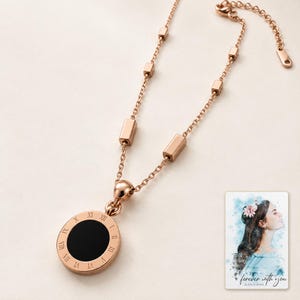 Roman Numeral Necklace, macro detail view. A personalized digital greeting card is shown alongside.