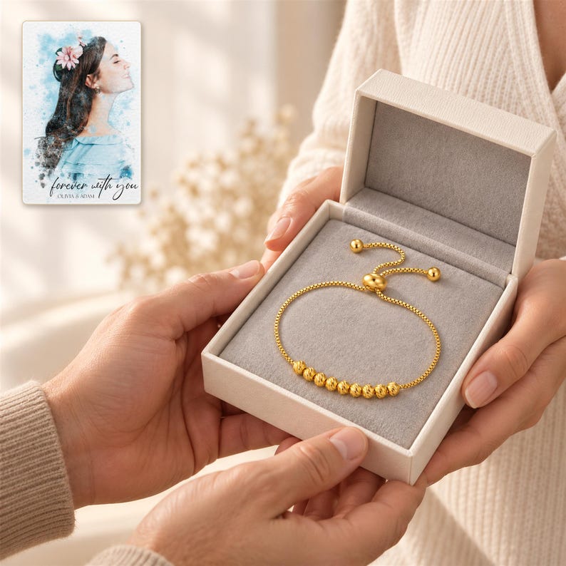 Golden Spiral Bead Slider Bracelet shown during a believable gift-giving moment between adults with the jewelry visible. A personalized digital greeting card is shown alongside.