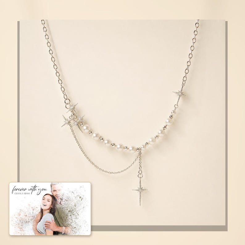 Silver-tone layered necklace with pale beads and pointed star charms, light-bordered product view. A personalized greeting-card example appears in the corner.