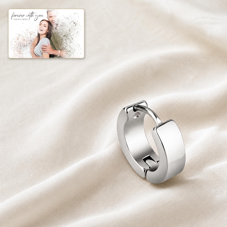 EdgeLine Stainless Huggie Hoops shown during a believable gift-giving moment between adults with the exact jewelry visible.