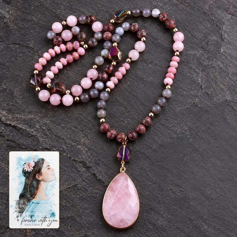 Pink teardrop pendant and mixed-color bead necklace on a dark neutral surface. A personalized digital greeting card is shown alongside.