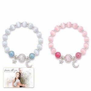 Starlit Moon Bead Bracelet shown during a believable gift-giving moment between adults with the exact jewelry visible.