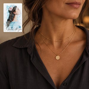 Gold Tone Coin Satellite Necklace worn by an adult in a polished evening lifestyle scene. A personalized digital greeting card is shown alongside.