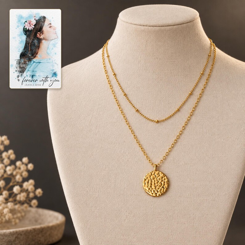 Gold Tone Coin Satellite Necklace styled against a dark luxury surface with the visible finish clearly visible. A personalized digital greeting card is shown alongside.