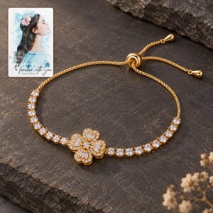 Golden Petal Slider Bracelet styled against a dark luxury surface with the exact product finish clearly visible. A personalized digital greeting card is shown alongside.