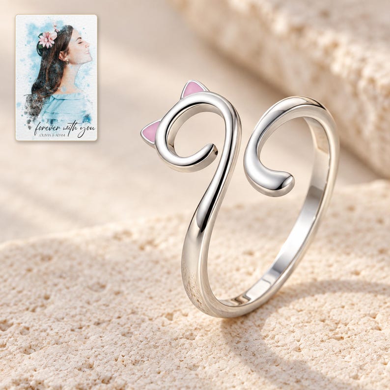 Close-up of the polished cat-head curl, pale pink ear triangles and separate smooth tail end. A personalized digital greeting card is shown alongside.
