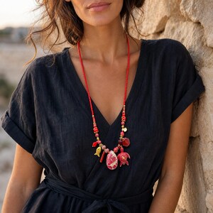 Three-piece handmade necklace set featuring gray and red beaded necklace, beige and gray beaded necklace and gray and brown beaded necklace, displayed together to show the coordinated colors and beadwork