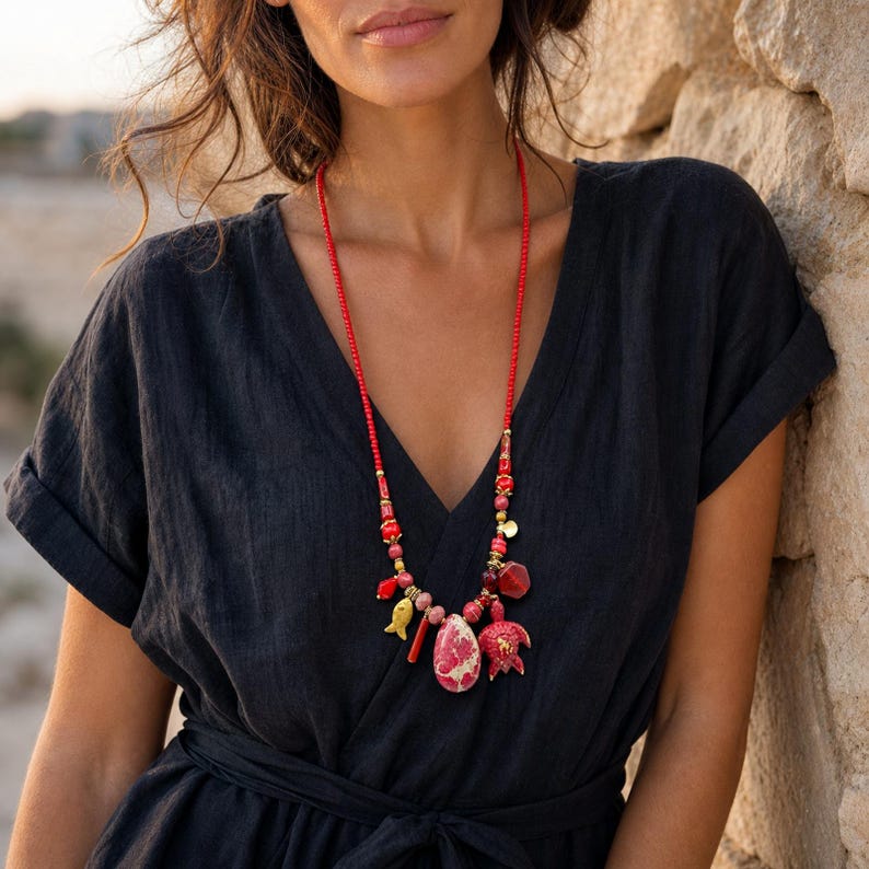 Three-piece handmade necklace set featuring gray and red beaded necklace, beige and gray beaded necklace and gray and brown beaded necklace, displayed together to show the coordinated colors and beadwork