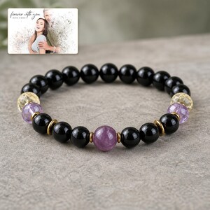 Violet Dusk Bead Bracelet photographed in warm natural window light in an elegant home setting.