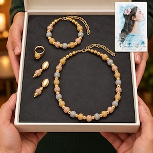 Metallic Bead Jewelry Suite shown during a warm gift-receiving moment between adults with the jewelry visible. A personalized digital greeting card is shown alongside.
