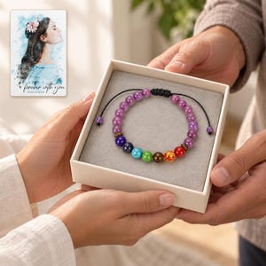 Violet Spectrum Cord Bracelet shown during a believable gift-giving moment between adults with the jewelry visible. A personalized digital greeting card is shown alongside.